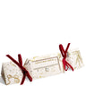 A boxed necklace displayed on a white background. The product is shown in its gift packaging, with a cream-colored box decorated with gold glittery illustrations of bows and stars, tied with red velvet ribbons on both sides.