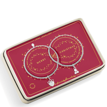 Two silver bracelets with charms on a red Joma Jewellery box.