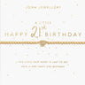 A gold beaded bracelet with a pavé heart charm and delicate chain, displayed on a white card with gold text celebrating a 21st birthday.