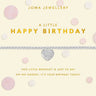 A silver heart charm bracelet by Joma Jewellery, presented on its cream-colored gift card with gold lettering and pink polka dots, set against a light gray background with matching confetti.
