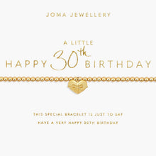 A gold beaded bracelet with a small heart-shaped pendant featuring a bow detail, presented on a white card with gold text celebrating a 30th birthday. The brand name 'JOMA JEWELLERY' is visible at the top.