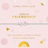 A silver friendship bracelet with a double heart charm on a light pink display card from Joma Jewellery. The card features gold lettering and decorative pink and gold polka dots, set against a clean white background with scattered confetti.