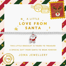 A silver beaded bracelet with a Santa Claus charm, presented on a decorative white card with Christmas-themed postage stamp designs and gold text. The brand 'Joma Jewellery' is visible at the bottom.
