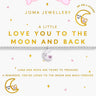 A Joma Jewellery bracelet displayed on its branded white card backing. The bracelet features a silver-toned chain with a small crescent moon charm and a separate white round bead with pink details.