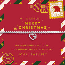 A Christmas-themed charm bracelet by Joma Jewellery, displayed on its red printed gift card. The bracelet itself is a delicate silver chain with a heart-shaped charm featuring a silver star and a small red heart.