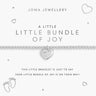 A silver baby bracelet with a heart-shaped charm engraved with 'little joy', presented on a white Joma Jewellery card that reads 'A LITTLE LITTLE BUNDLE OF JOY'.