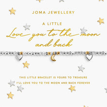 A silver beaded bracelet with a gold crescent moon charm and two small silver heart charms, displayed on a white Joma Jewellery gift card with gold lettering, surrounded by scattered gold and silver stars.