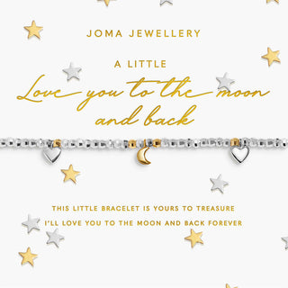 A silver beaded bracelet with a gold crescent moon charm and two small silver heart charms, displayed on a white Joma Jewellery gift card with gold lettering, surrounded by scattered gold and silver stars.
