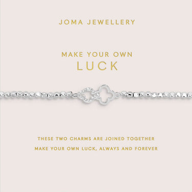 Silver bracelet with two charms on a Joma Jewellery display card.