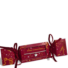 A Christmas-themed jewelry box set by Joma Jewellery, featuring a silver beaded necklace with a star charm displayed in the center red box, flanked by two matching red boxes with gold starry patterns and ribbon bows.