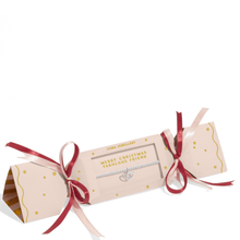Jewelry cracker with red ribbons on a white background