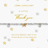 A silver and gold beaded bracelet with a bow charm and crystal accents, presented on a white card that reads 'JOMA JEWELLERY A LITTLE Thank you'. The card is decorated with scattered gold and silver stars on a white background.