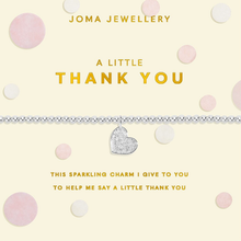 Joma Jewellery heart-shaped charm on a chain with text on a polka dot background