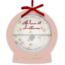 A Joma Jewellery Christmas ornament-shaped gift box with a pink silhouette, gold star details, a red ribbon bow at the top, and a clear front window showing a silver and gold heart-and-stars bracelet inside. The box reads 'Joma Jewellery with love at christmas' and 'Christmas Wishes'.