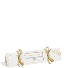 Christmas cracker with gold ribbons on a white background