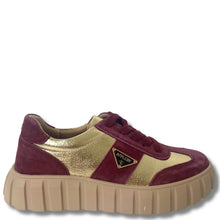 Gold and burgundy sneaker with a visible brand logo on a white background
