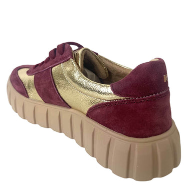 Maroon and gold sneaker with beige sole on a white background