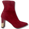 Red suede ankle boot with gold heel on a white background