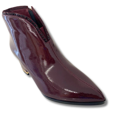 Shiny burgundy ankle boot on a white background