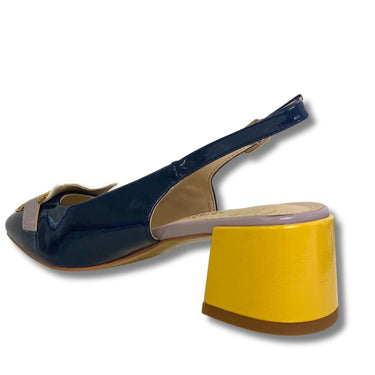 Navy blue high-heeled shoe with yellow sole on a white background