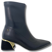 Black ankle boot with gold heel on a white background