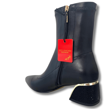 Black ankle boot with gold heel and rhinestone details on a white background