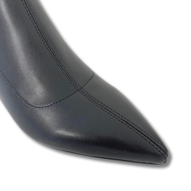 Close-up of a black leather shoe with a pointed toe on a white background