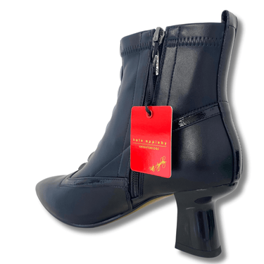 Black ankle boot with a red tag on a white background