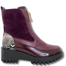 A low-top platform ankle boot featuring a deep burgundy colorway with a mix of matte suede, glossy patent leather, and a snakeskin-patterned heel panel, finished with a chunky black lug sole.