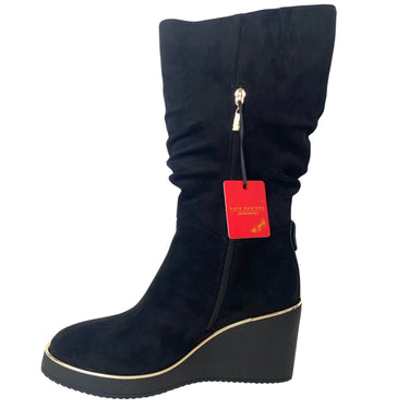Black wedge boot with a red tag on a white background