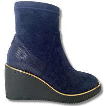 Blue wedge ankle boot on a white background