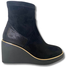 Black wedge ankle boot on a white background