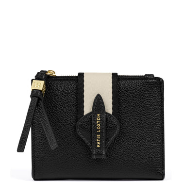 A black pebbled leather wallet by Katie Loxton, featuring a vertical cream-colored stripe down the center, a matching leather tab with gold-embossed branding, and a gold-tone zipper pull.
