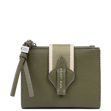 An olive green pebbled leather wallet by Kate Loxton, featuring a vertical cream and olive green striped fabric accent, a matching leather tassel zipper pull, and a central shield-shaped leather detail with the brand name printed vertically.