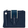 A navy blue pebbled leather card holder wallet by Katie Loxton, featuring a vertical navy and cream stripe on the front, a matching leather arrow-shaped tab with the brand name, and a leather tassel zipper pull.