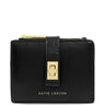 A black leather wallet by Katie Loxton with a gold-tone metal clasp and zipper pull, shown on a plain white background.