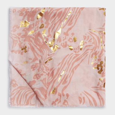 Folded fabric with pink and gold abstract pattern on a white background