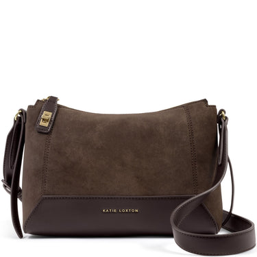 A Katie Loxton crossbody bag in dark brown suede and smooth leather, featuring gold-tone hardware and the brand name printed in gold on the front.