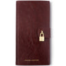 A dark burgundy leather wallet with a small gold padlock closure and gold 'KATIE LOXTON' branding at the bottom, shown on a plain white background.