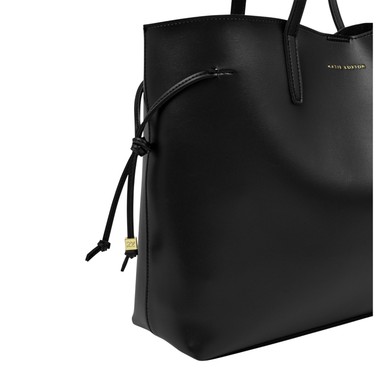 Black leather handbag with drawstring detail on a white background