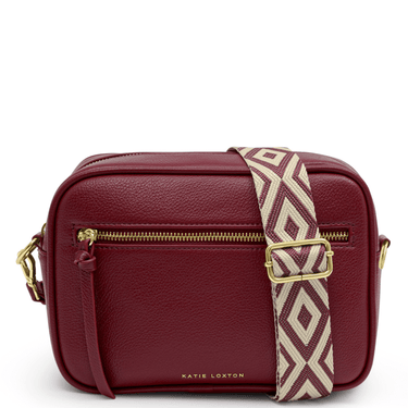 Red handbag with a patterned strap on a white background