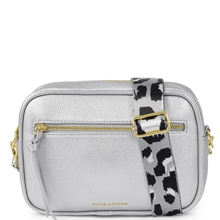 Silver crossbody bag with a patterned strap on a white background