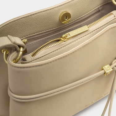 Beige handbag with gold accents on a white background