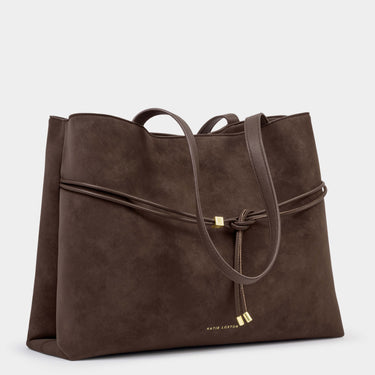 Brown leather handbag with a strap on a light gray background