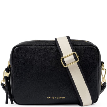 A black pebbled leather crossbody bag by Katie Loxton with a wide cream-colored shoulder strap featuring black trim and a gold buckle, shown on a plain white background.