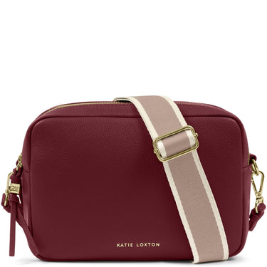 A Katie Loxton burgundy pebbled leather camera bag with a beige and white striped webbing strap and gold-tone hardware, shown on a white background.