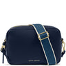 A navy blue pebbled leather camera bag by Katie Loxton, featuring a wide navy strap with a white center stripe and gold-tone hardware, on a white background.