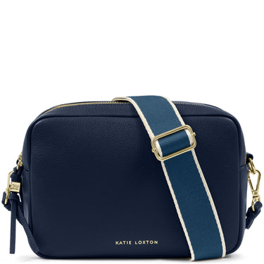 A navy blue pebbled leather camera bag by Katie Loxton, featuring a wide navy strap with a white center stripe and gold-tone hardware, on a white background.