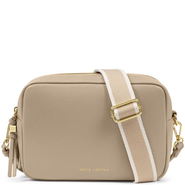 A Katie Loxton crossbody bag in beige pebbled leather with a wide beige and white striped webbing strap and gold-tone hardware, shown on a plain white background.