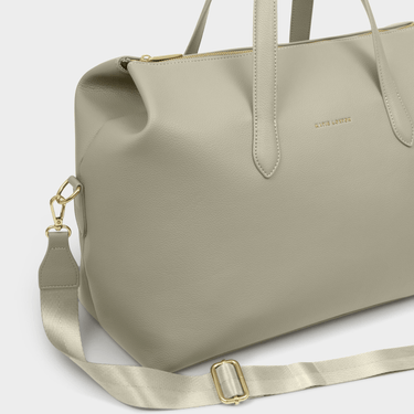 large green bag with gold accents on a white background